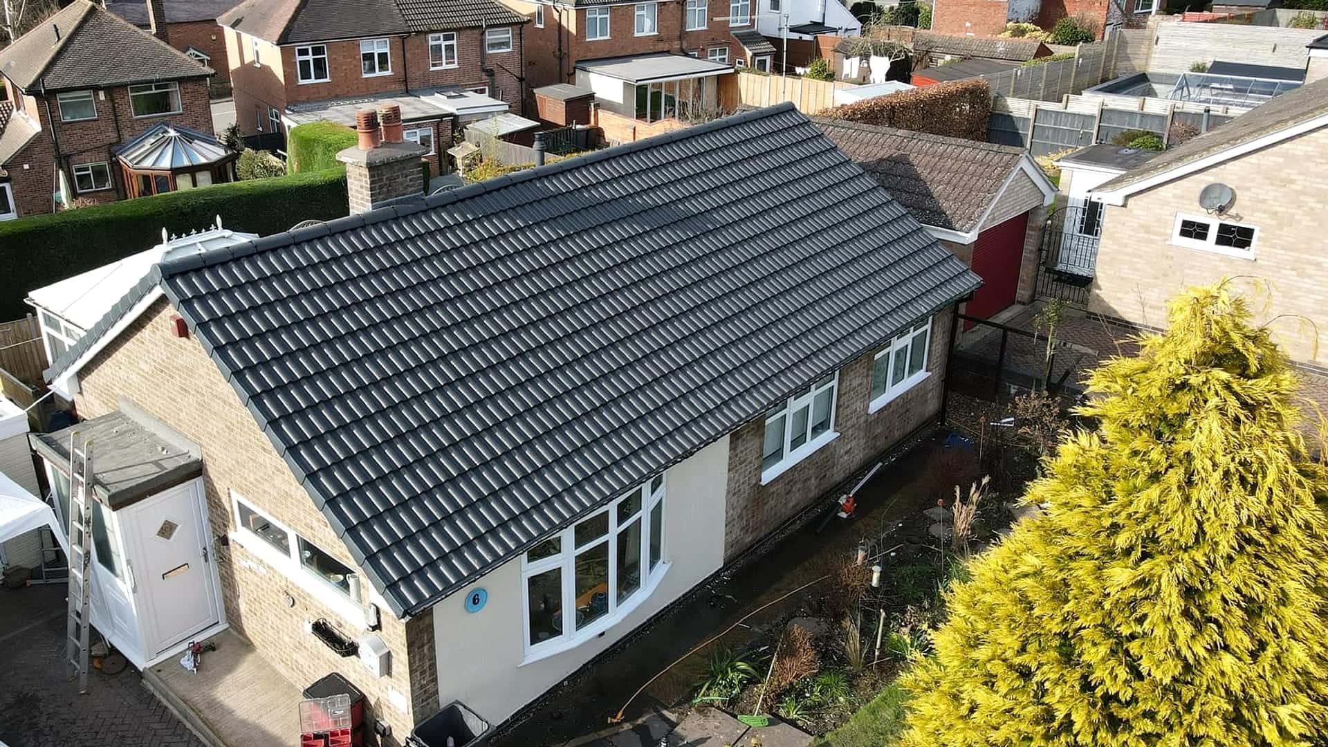 Completed re-roof with new dark grey tiles by Armour Shield Roofing Services