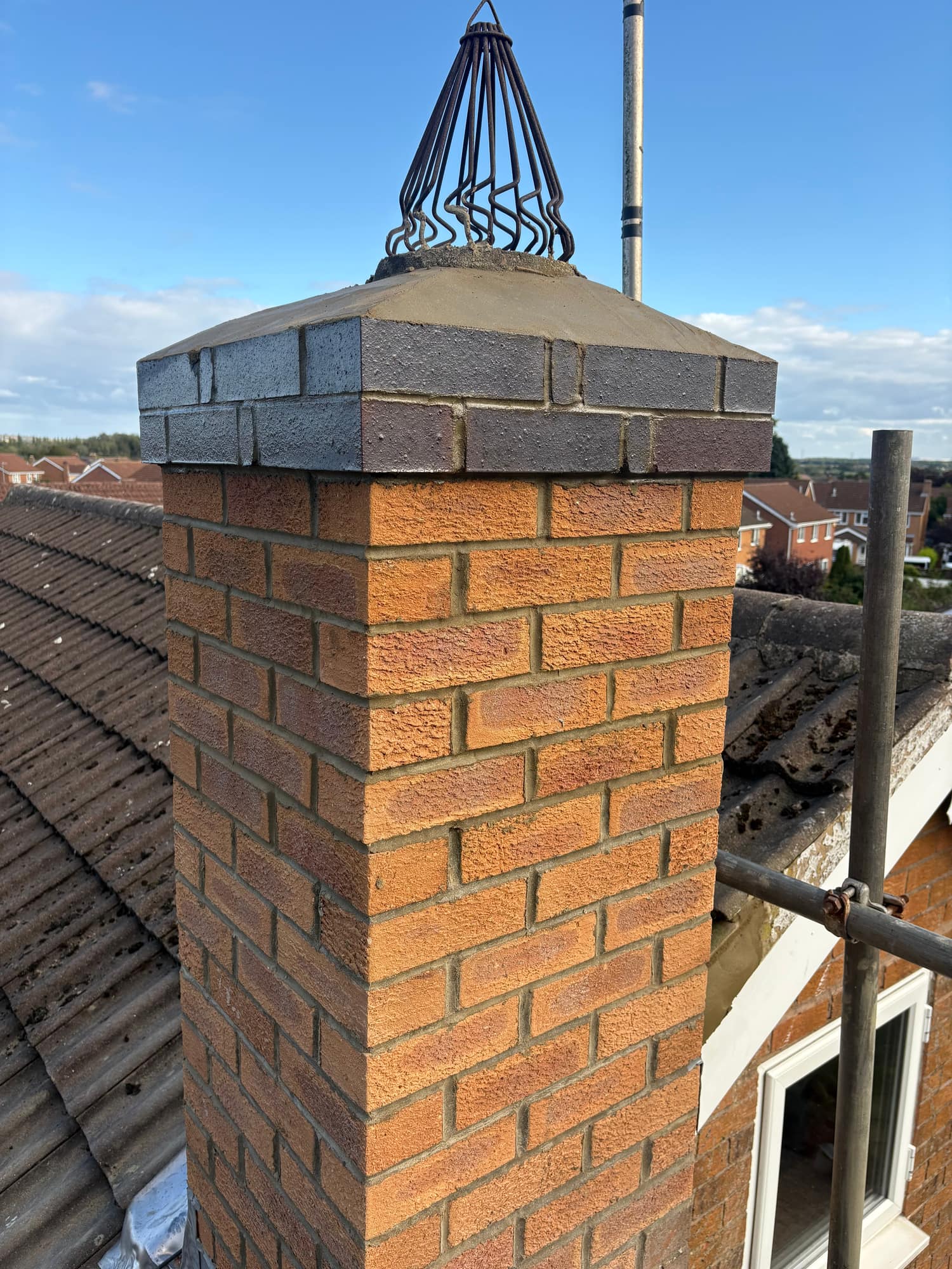 Chimney stack in Beverley rebuilt in new brick from the roofline up, with new flaunching and a bird guard — Armour Shield Roofing Services