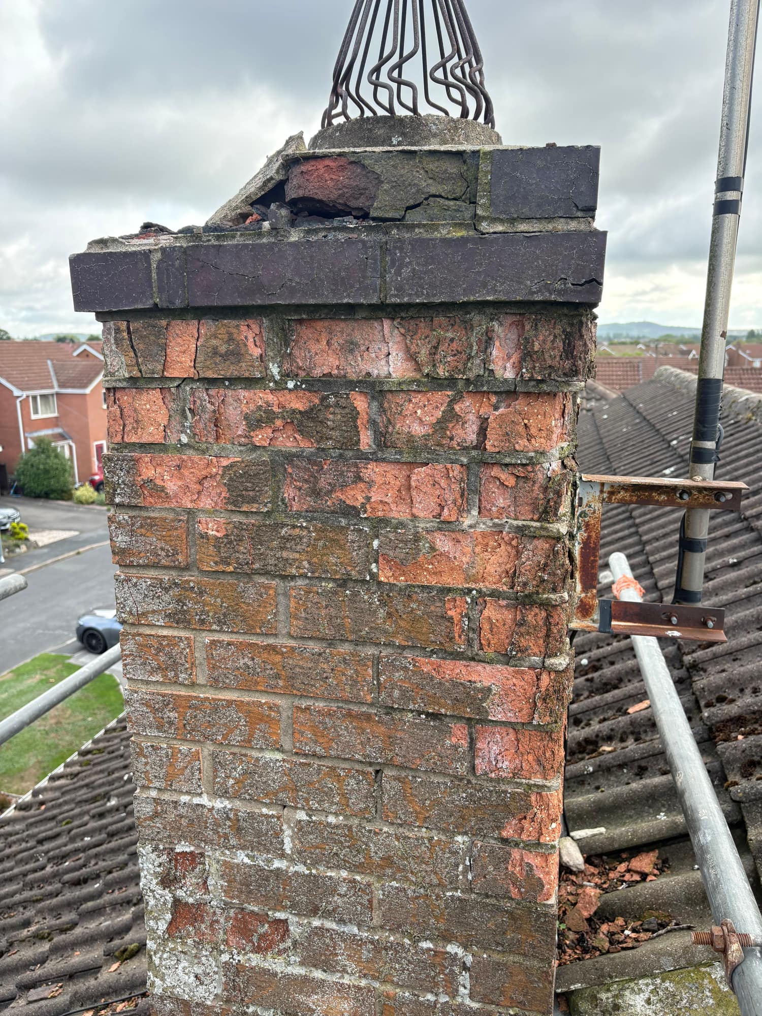 Badly eroded chimney stack in Beverley before rebuilding, with spalled bricks and cracked flaunching — Armour Shield Roofing Services