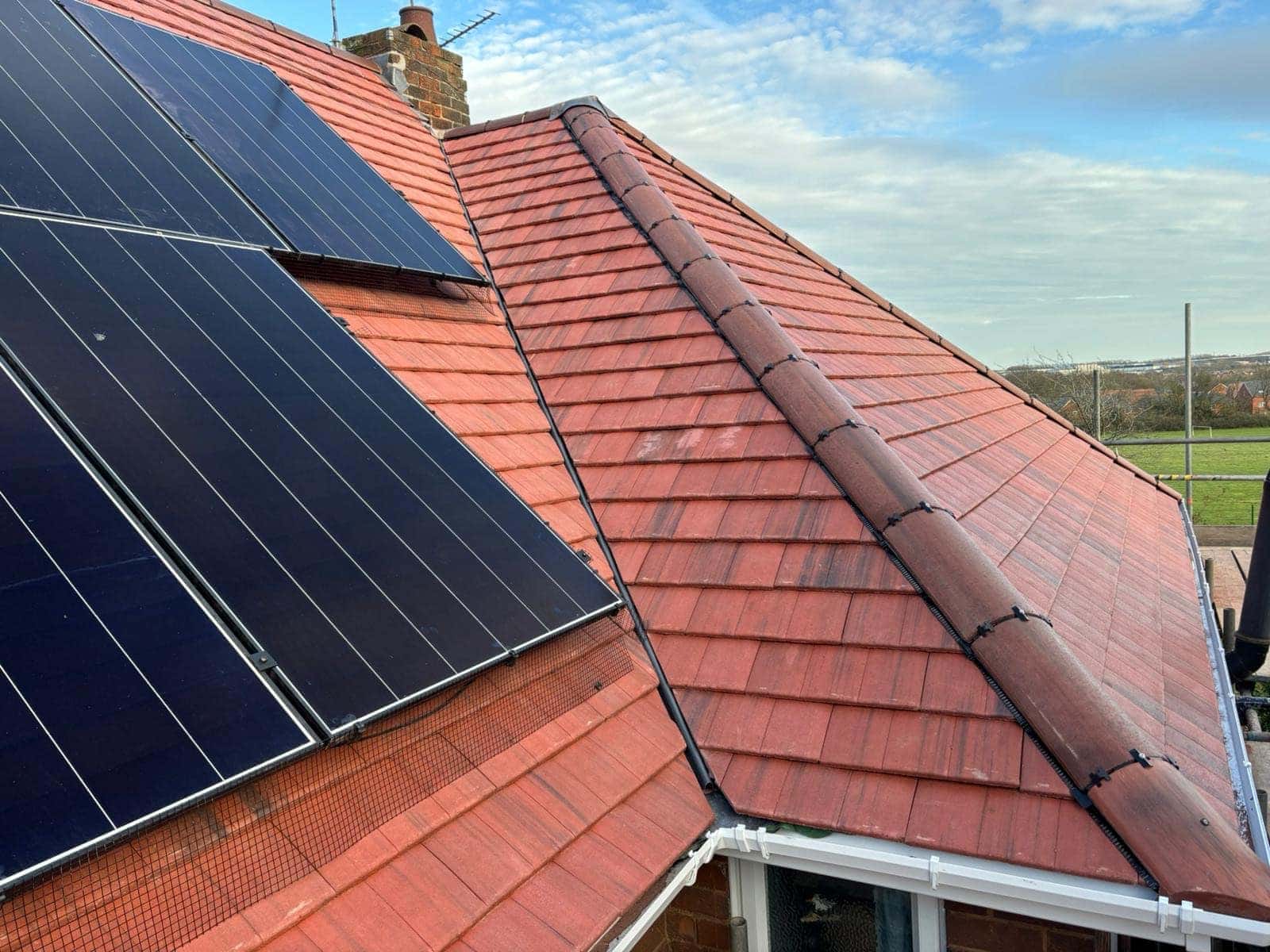 Dry valley between two slopes of a new Russell Bute 3 tiled roof in York, beside solar panels — Armour Shield Roofing Services