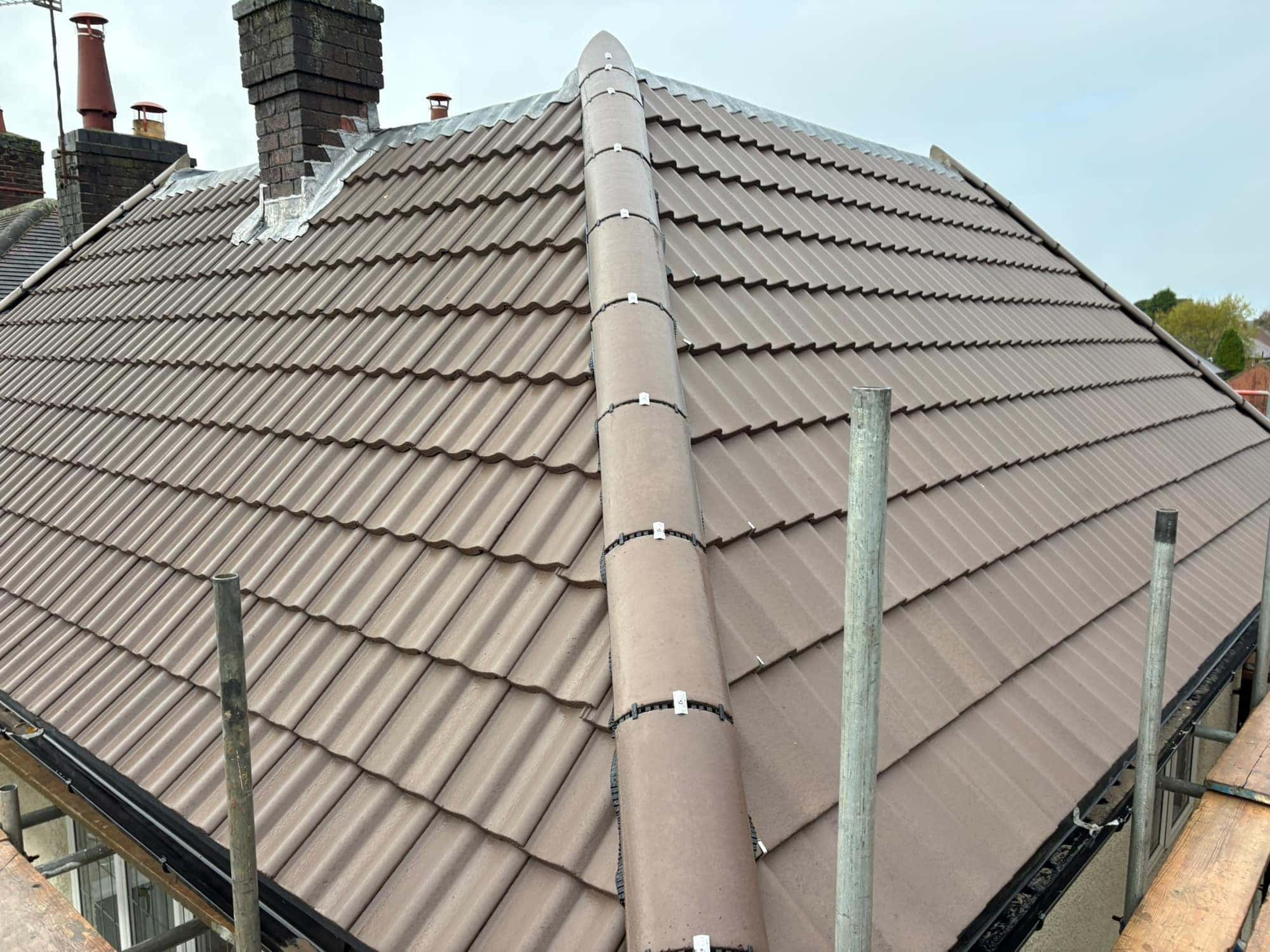 Dry hip on a new brown Sandtoft double pantile roof in Beverley, with new lead flashing to the chimney — Armour Shield Roofing Services